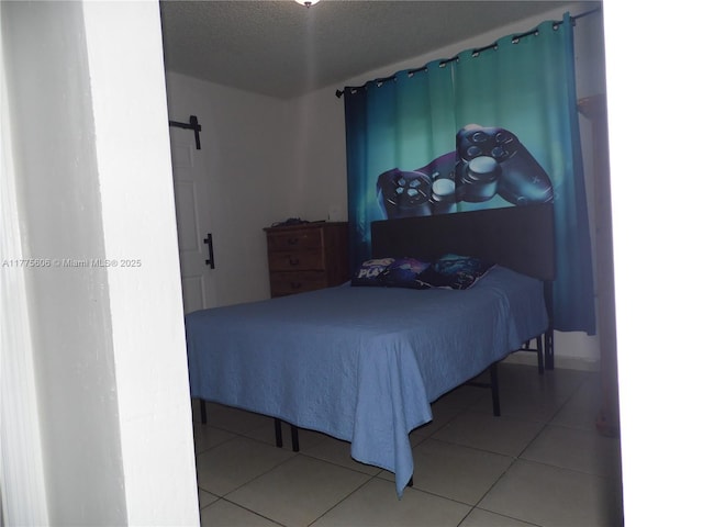 3491 Palm Ave, Hialeah, FL 33012 - bedroom with a barn door, tile patterned floors, and a textured ceiling