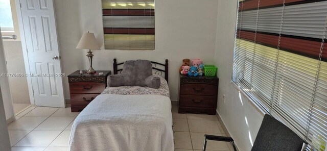 3491 Palm Ave, Hialeah, FL 33012 - tiled bedroom with baseboards