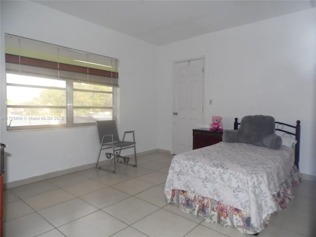 3491 Palm Ave, Hialeah, FL 33012 - tiled bedroom with baseboards