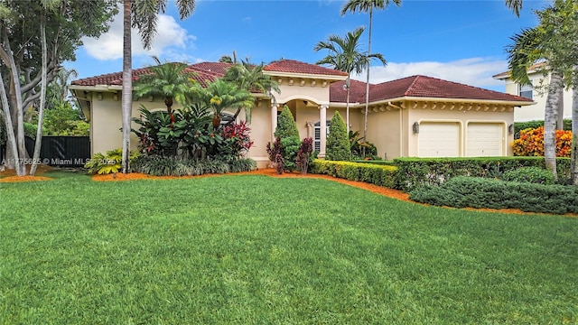 mediterranean / spanish-style home with an attached garage, stucco siding, and a tiled roof