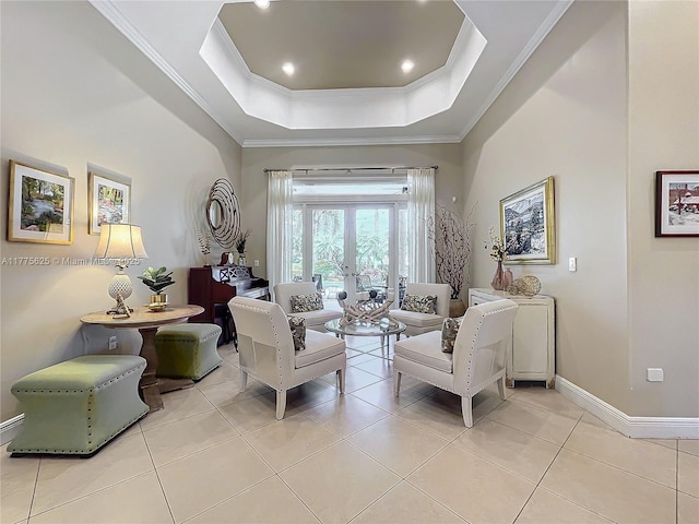 living area featuring french doors, ornamental molding, baseboards, light tile patterned floors, and a tray ceiling