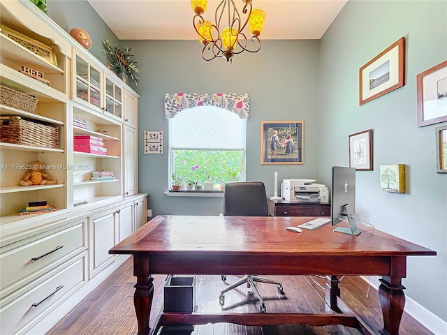 office with dark wood-style flooring and a chandelier