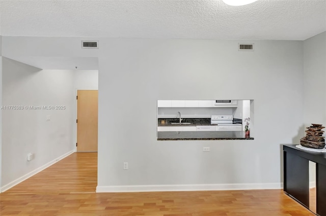 9805 NW 52nd St Unit 306, Doral, FL 33178 - hallway featuring a textured ceiling, light wood-style flooring, and visible vents
