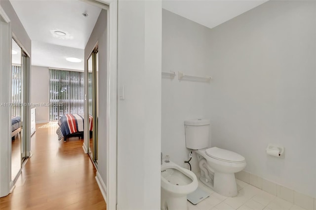 9805 NW 52nd St Unit 306, Doral, FL 33178 - ensuite bathroom featuring baseboards, connected bathroom, toilet, and a bidet