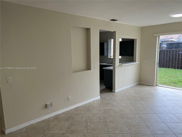 100 SW 15th Ave, Homestead, FL 33030 - unfurnished room with light tile patterned flooring, a sink, and baseboards