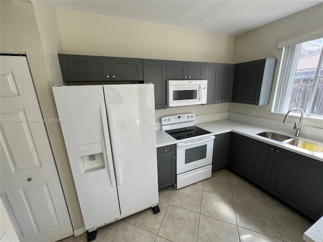 100 SW 15th Ave, Homestead, FL 33030 - kitchen featuring white appliances, a sink, light countertops, and light tile patterned flooring