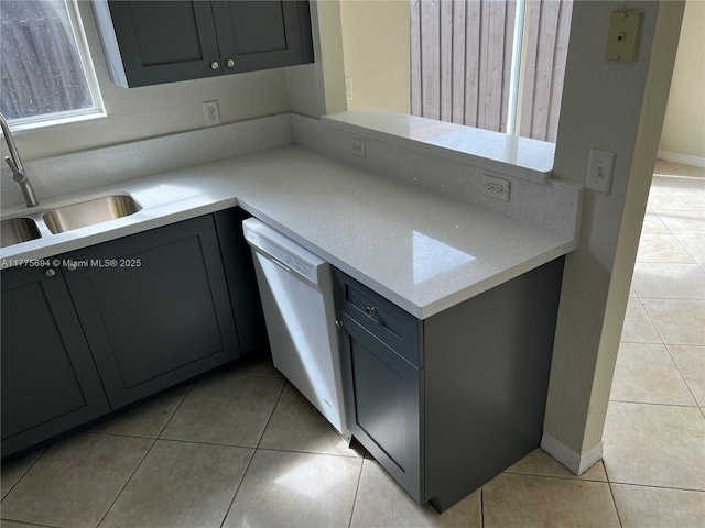 100 SW 15th Ave, Homestead, FL 33030 - kitchen featuring dishwasher, light tile patterned floors, a sink, gray cabinets, and baseboards