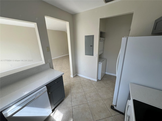 100 SW 15th Ave, Homestead, FL 33030 - kitchen with white appliances, electric panel, light countertops, light tile patterned floors, and baseboards