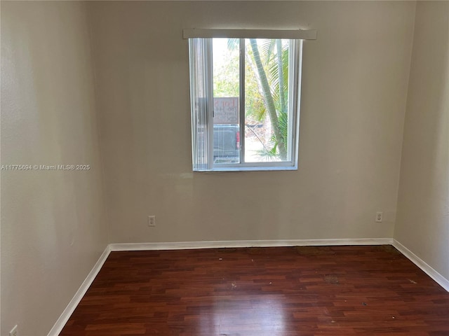 100 SW 15th Ave, Homestead, FL 33030 - empty room featuring plenty of natural light, dark wood-type flooring, and baseboards