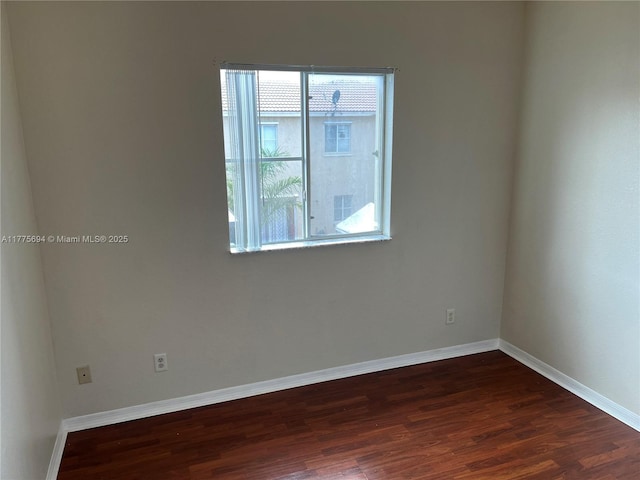 100 SW 15th Ave, Homestead, FL 33030 - empty room featuring plenty of natural light, dark wood finished floors, and baseboards