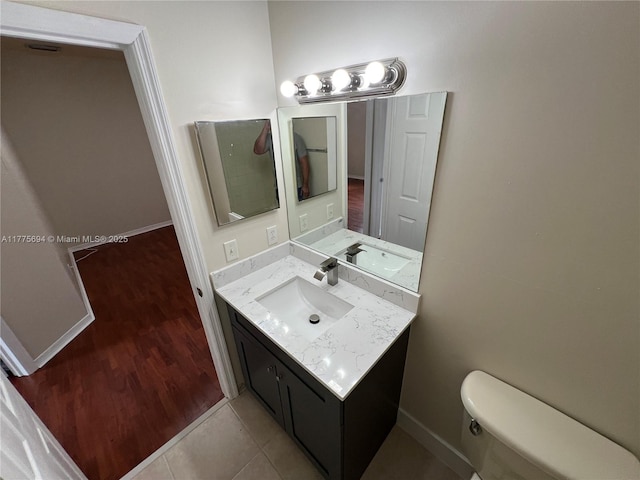 100 SW 15th Ave, Homestead, FL 33030 - bathroom with toilet, vanity, wood finished floors, and baseboards