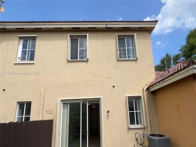 100 SW 15th Ave, Homestead, FL 33030 - back of house with stucco siding, central AC, and fence