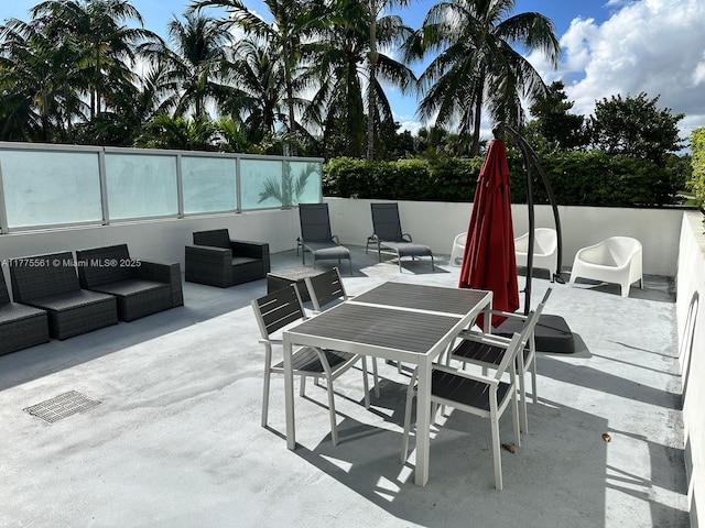 view of patio / terrace with fence, outdoor dining space, an outdoor living space, and visible vents