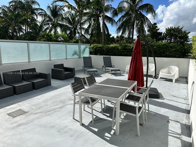 2001 Meridian Ave Unit 309, Miami Beach, FL 33139 - view of patio featuring outdoor lounge area, outdoor dining space, and fence