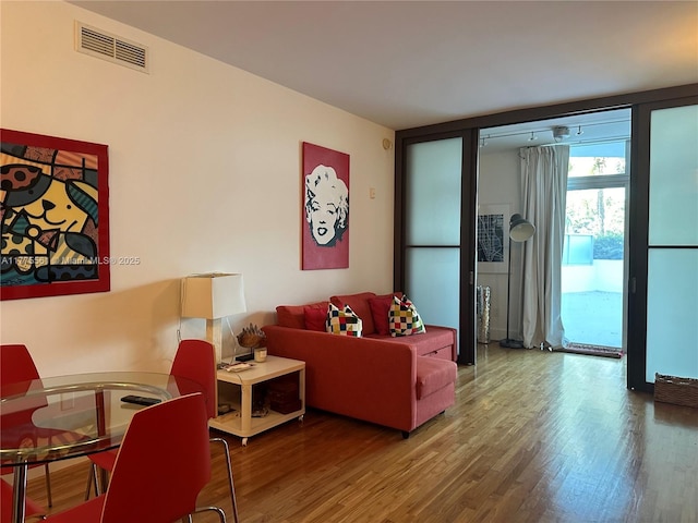 living room with visible vents and wood finished floors