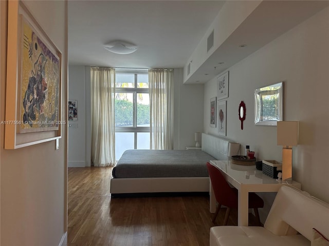 bedroom featuring visible vents and wood finished floors