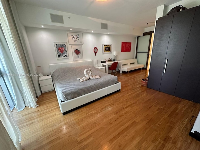 bedroom with visible vents, recessed lighting, and wood finished floors