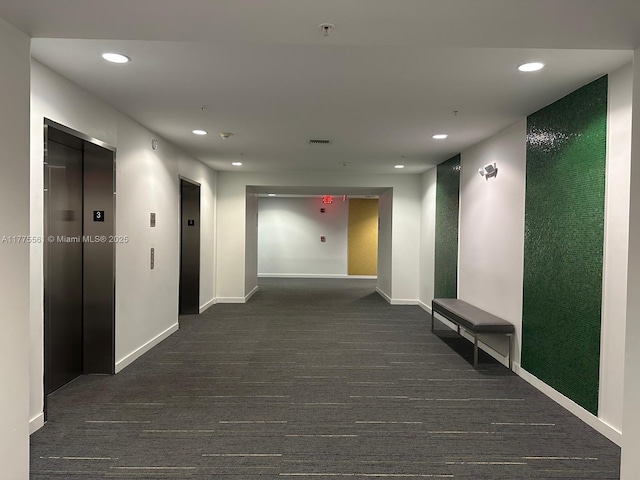 corridor featuring recessed lighting, elevator, and baseboards