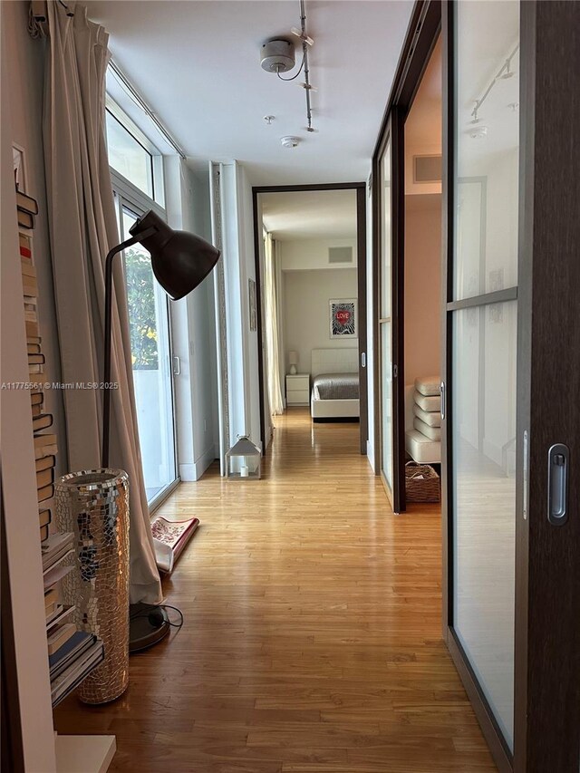 2001 Meridian Ave Unit 309, Miami Beach, FL 33139 - corridor featuring track lighting and light wood-style floors