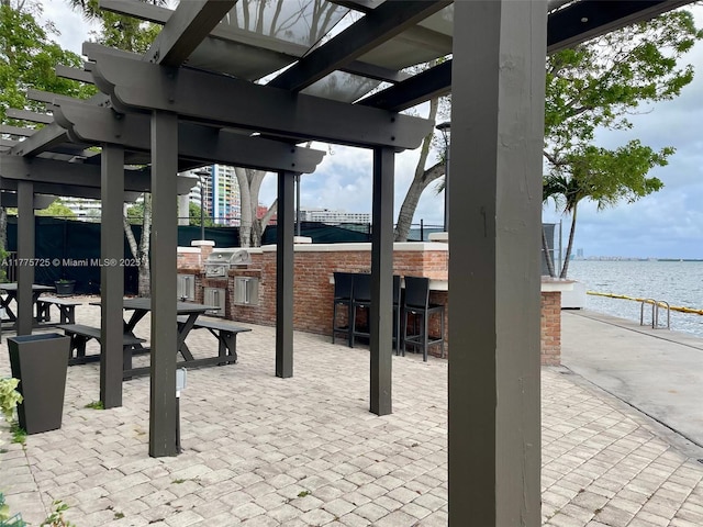 1901 Brickell Ave Unit B804, Miami, FL 33129 - view of patio with an outdoor kitchen, a pergola, a water view, and outdoor wet bar