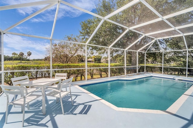 outdoor pool with a patio and glass enclosure