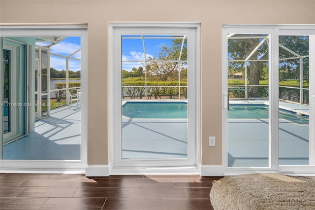 doorway featuring baseboards and wood tiled floors