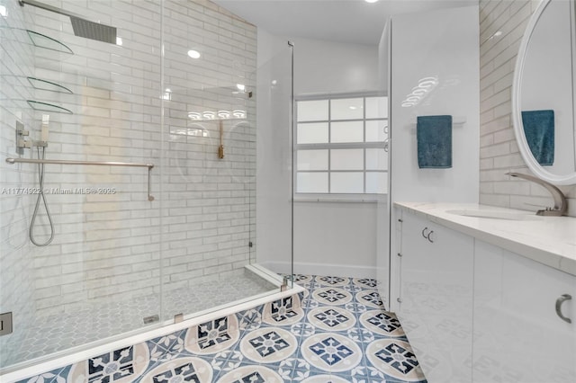 bathroom featuring a shower stall, tile patterned flooring, and vanity