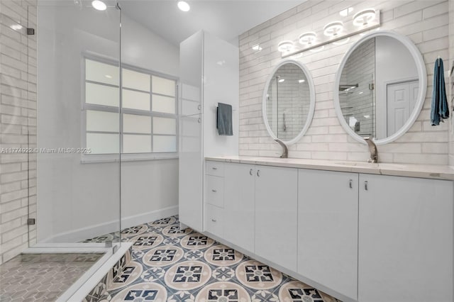 full bath featuring tasteful backsplash, a tile shower, vanity, tile patterned floors, and vaulted ceiling