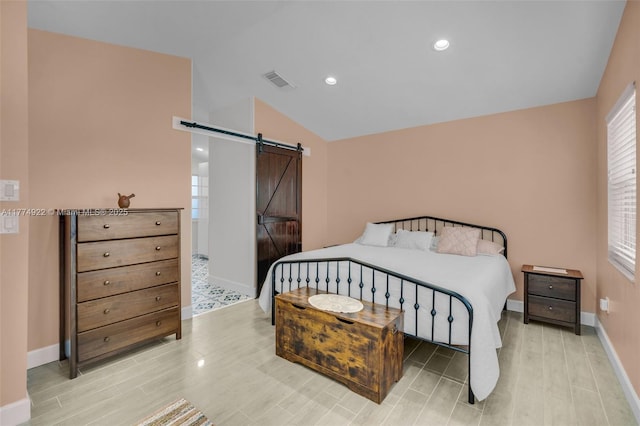 bedroom featuring a barn door, light wood-type flooring, vaulted ceiling, baseboards, and recessed lighting
