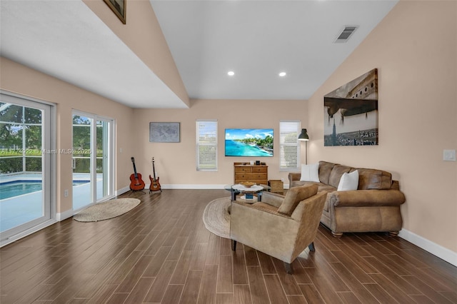 living area with baseboards, dark wood-style floors, recessed lighting, and high vaulted ceiling