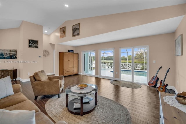 living room featuring dark wood-style flooring, baseboards, high vaulted ceiling, and recessed lighting