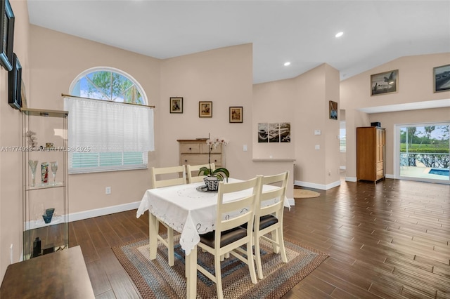 dining room featuring wood finished floors, baseboards, lofted ceiling, and recessed lighting