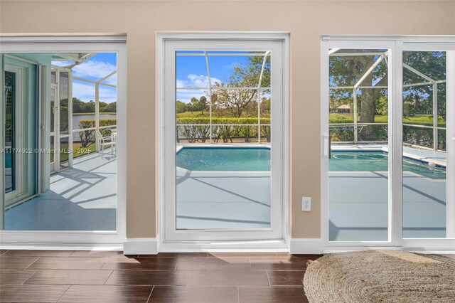 doorway featuring baseboards and wood tiled floors