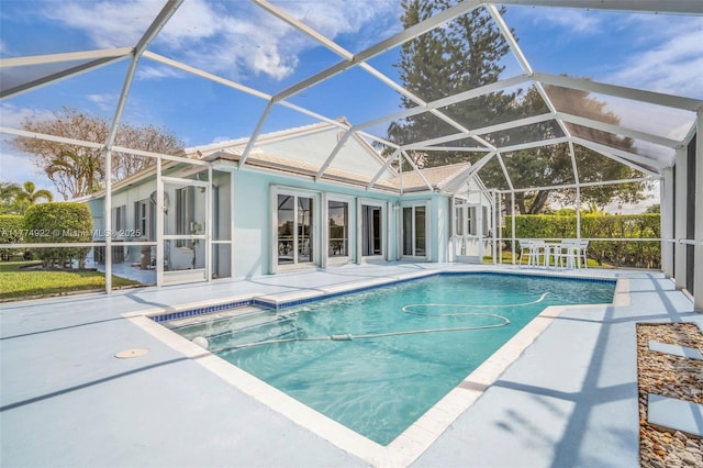 swimming pool with a patio area and a lanai