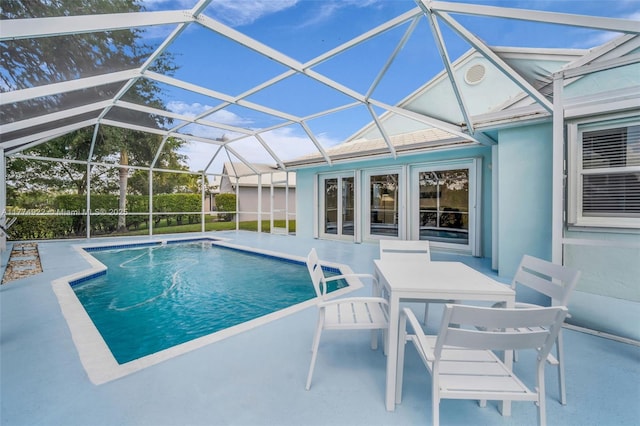 outdoor pool featuring a patio area and a lanai