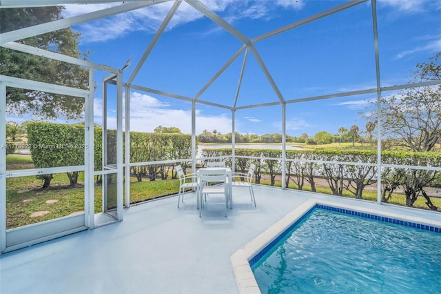 swimming pool featuring a patio and glass enclosure