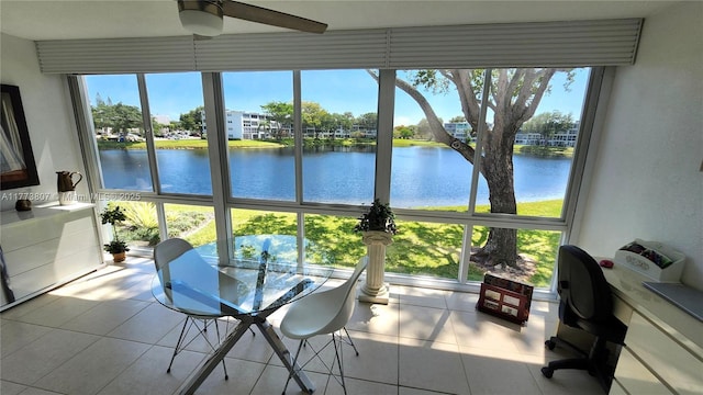 sunroom with plenty of natural light and a water view