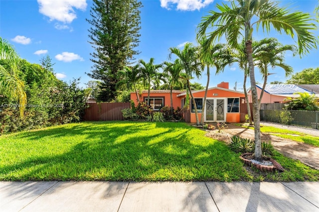 view of yard featuring concrete driveway and fence