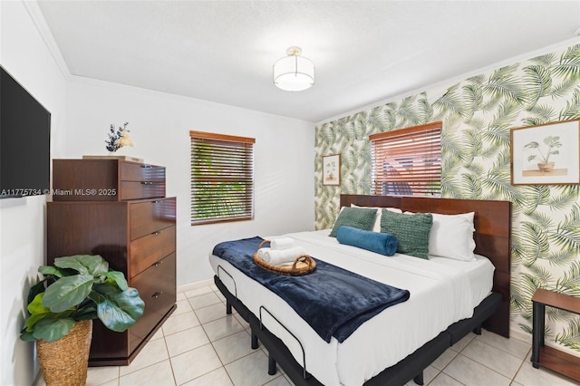 bedroom with wallpapered walls, light tile patterned floors, an accent wall, crown molding, and baseboards