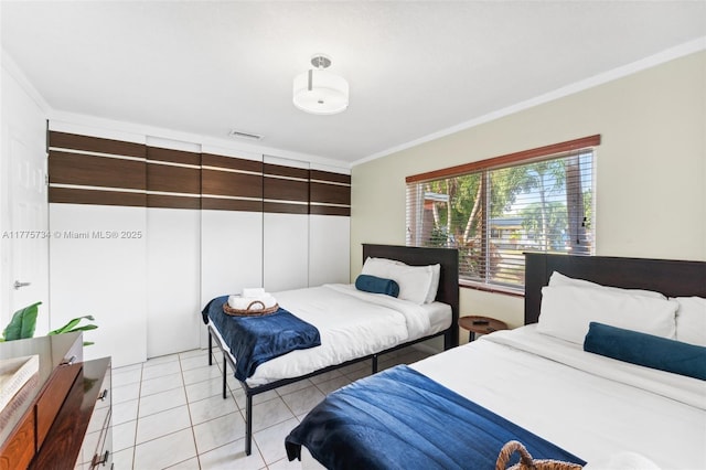 bedroom featuring light tile patterned flooring, crown molding, and visible vents