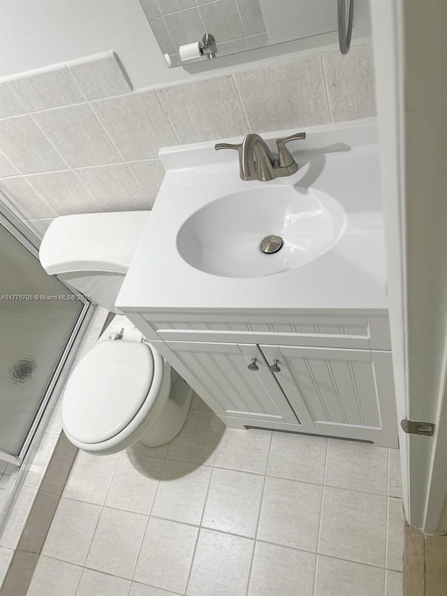 447 NE 195th St Unit 217, Miami, FL 33179 - bathroom with toilet, vanity, tile patterned flooring, and a shower stall