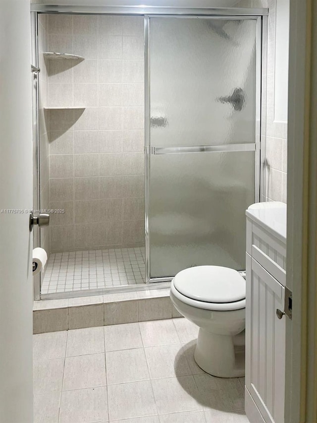 447 NE 195th St Unit 217, Miami, FL 33179 - full bath featuring toilet, vanity, a stall shower, and tile patterned flooring