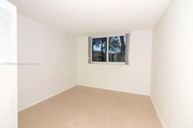 447 NE 195th St Unit 217, Miami, FL 33179 - spare room featuring baseboards