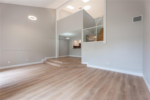 4291 S Pine Island Rd, Davie, FL 33328 - spare room with a towering ceiling and wood finished floors