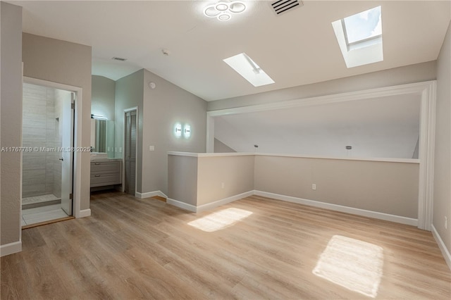 4291 S Pine Island Rd, Davie, FL 33328 - unfurnished room featuring a skylight, lofted ceiling, and light wood-style flooring