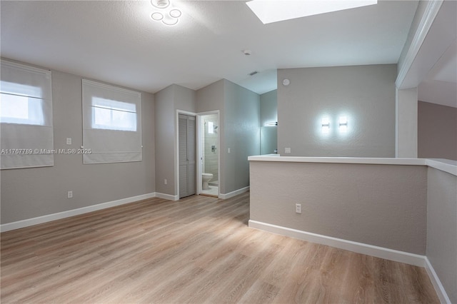 4291 S Pine Island Rd, Davie, FL 33328 - unfurnished room with light wood-style floors, a skylight, and vaulted ceiling