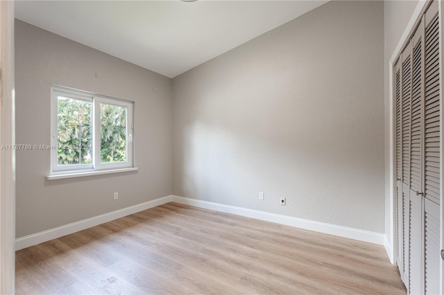 4291 S Pine Island Rd, Davie, FL 33328 - unfurnished bedroom with light wood finished floors, a closet, and a heating unit