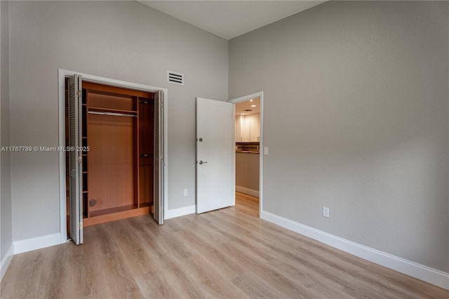 4291 S Pine Island Rd, Davie, FL 33328 - unfurnished bedroom with light wood finished floors, high vaulted ceiling, and a closet