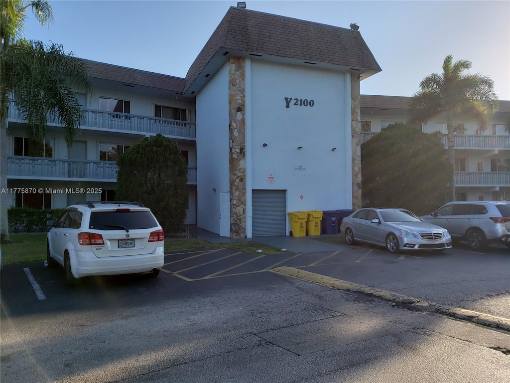 view of building exterior with uncovered parking