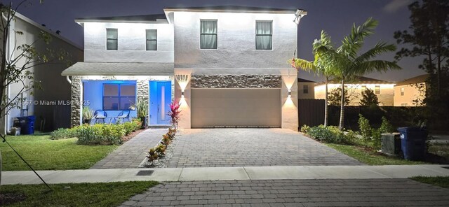 12973SW 266th Ter, Homestead, FL 33032 - view of front of house with decorative driveway, stucco siding, and a garage